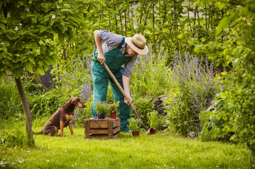 Gardener preparing to work in a Chelsea front garden with tools